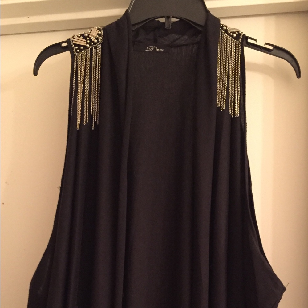 Cute vest with blingy shoulder accents.